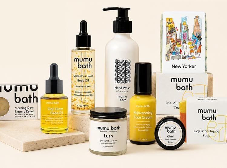 Flat lay of natural soap bars, body oils, and skincare products from mumu bath on earthy pedestals