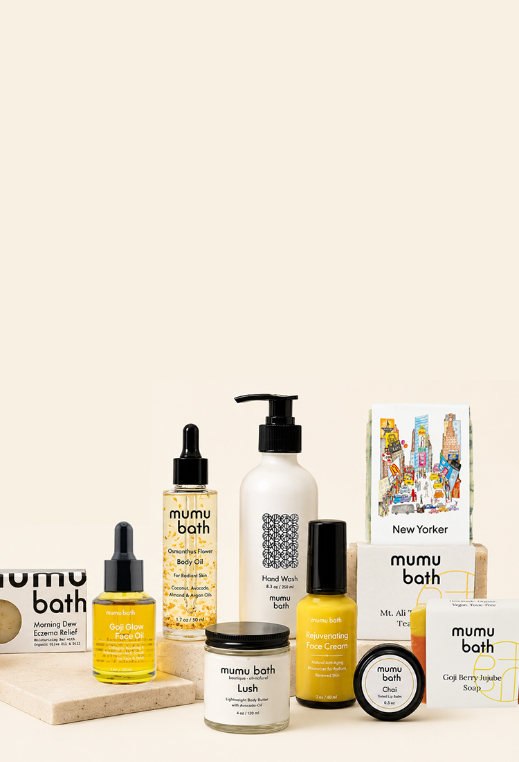 Flat lay of natural soap bars, body oils, and skincare products from mumu bath on earthy pedestals